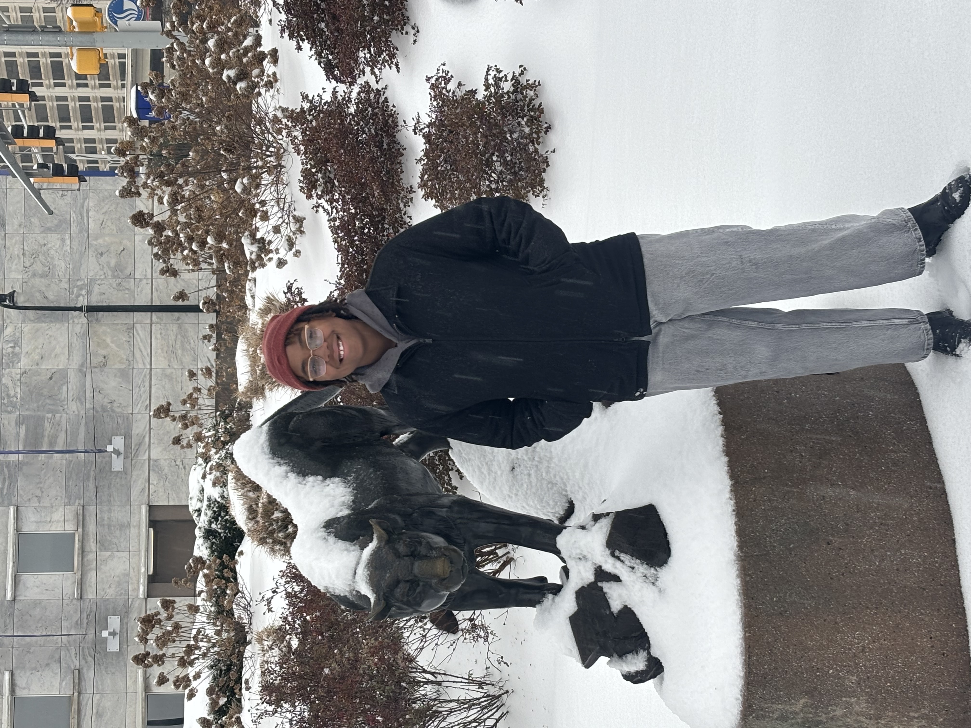 An image of Morgan Guinyard. She is standing in front of a snow-covered panther statue on Georgia State University's campus.